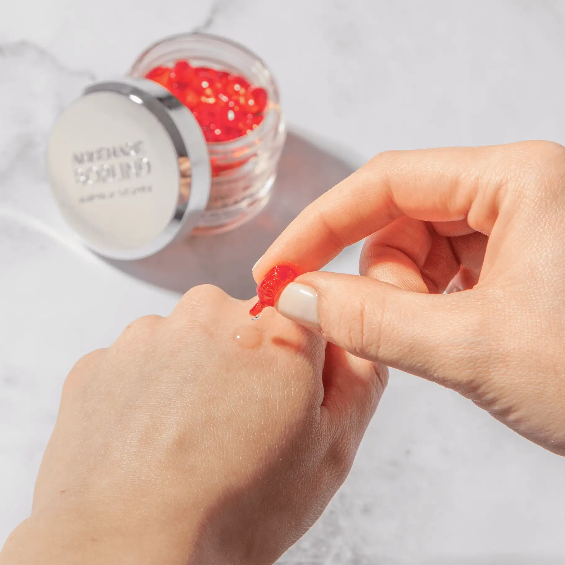 ANNEMARIE BÖRLIND Intensiv-Pflege-Kapsel wird auf die Hand aufgetragen, geöffnete Kapsel mit Serum sichtbar