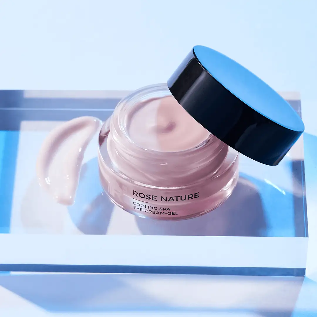 ROSE NATURE Cooling Spa Eye Cream-Gel im geöffneten Tiegel mit Cremeprobe auf blauem Untergrund