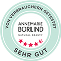 ANNEMARIE BÖRLIND Testsiegel mit fünf roten Sternen und Text „Sehr gut“ in grünem Kreis