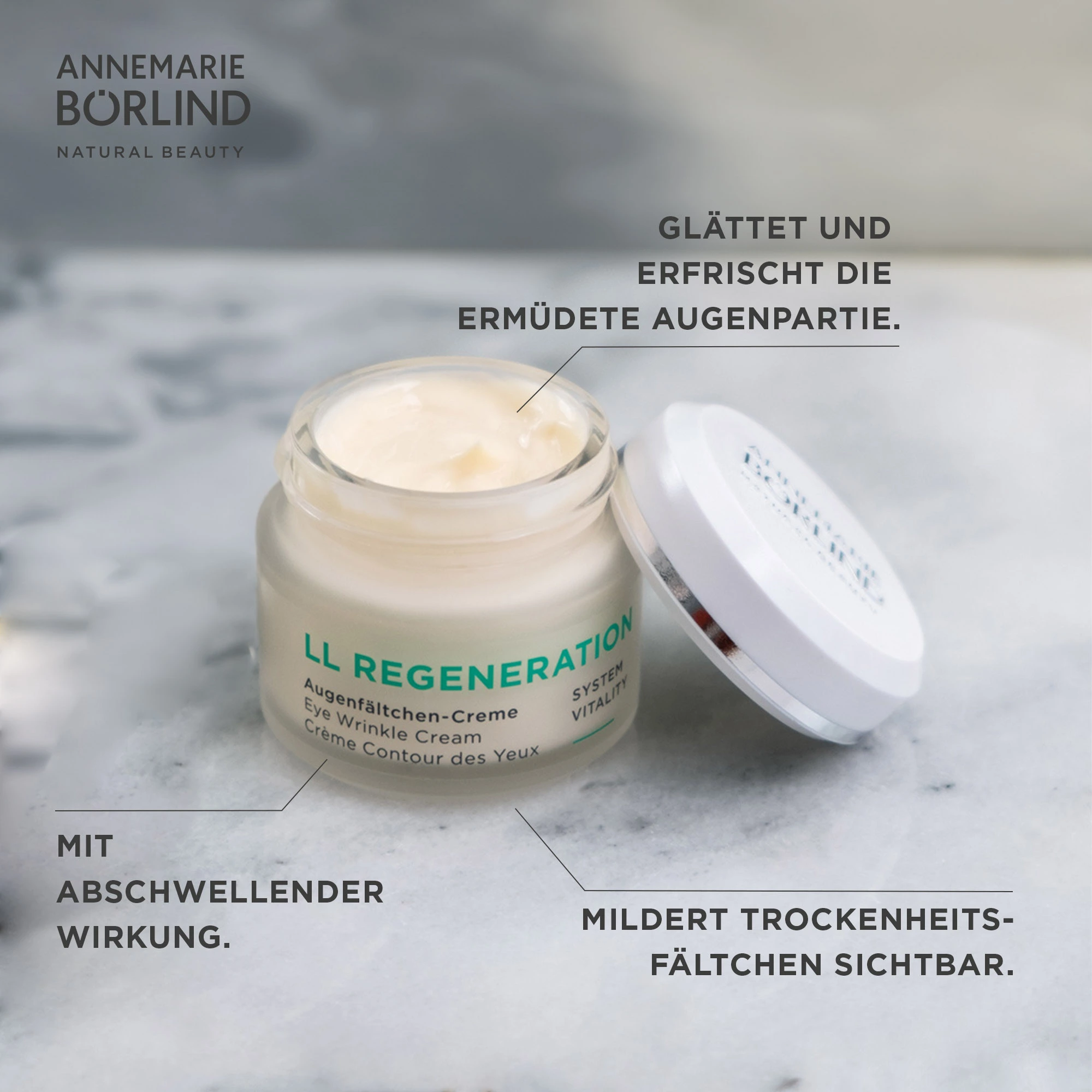 ANNEMARIE BÖRLIND LL REGENERATION Augenfältchen-Creme im geöffneten Tiegel auf Marmoroberfläche