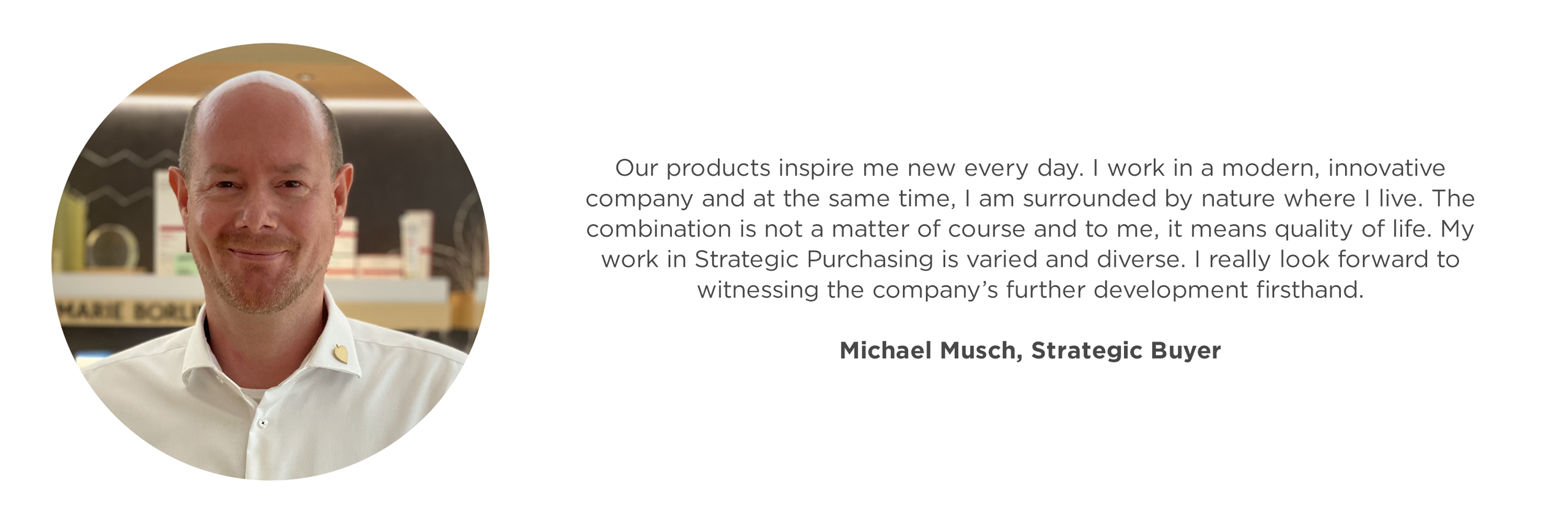 Porträt eines lächelnden Mannes in weißem Hemd vor einem Regal mit Kosmetikprodukten, Mitarbeitermeinung