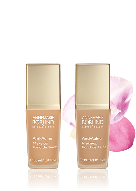 ANNEMARIE BÖRLIND Anti-Aging Make-up Grundierung in zwei Farbtönen vor rosa Blütenblatt