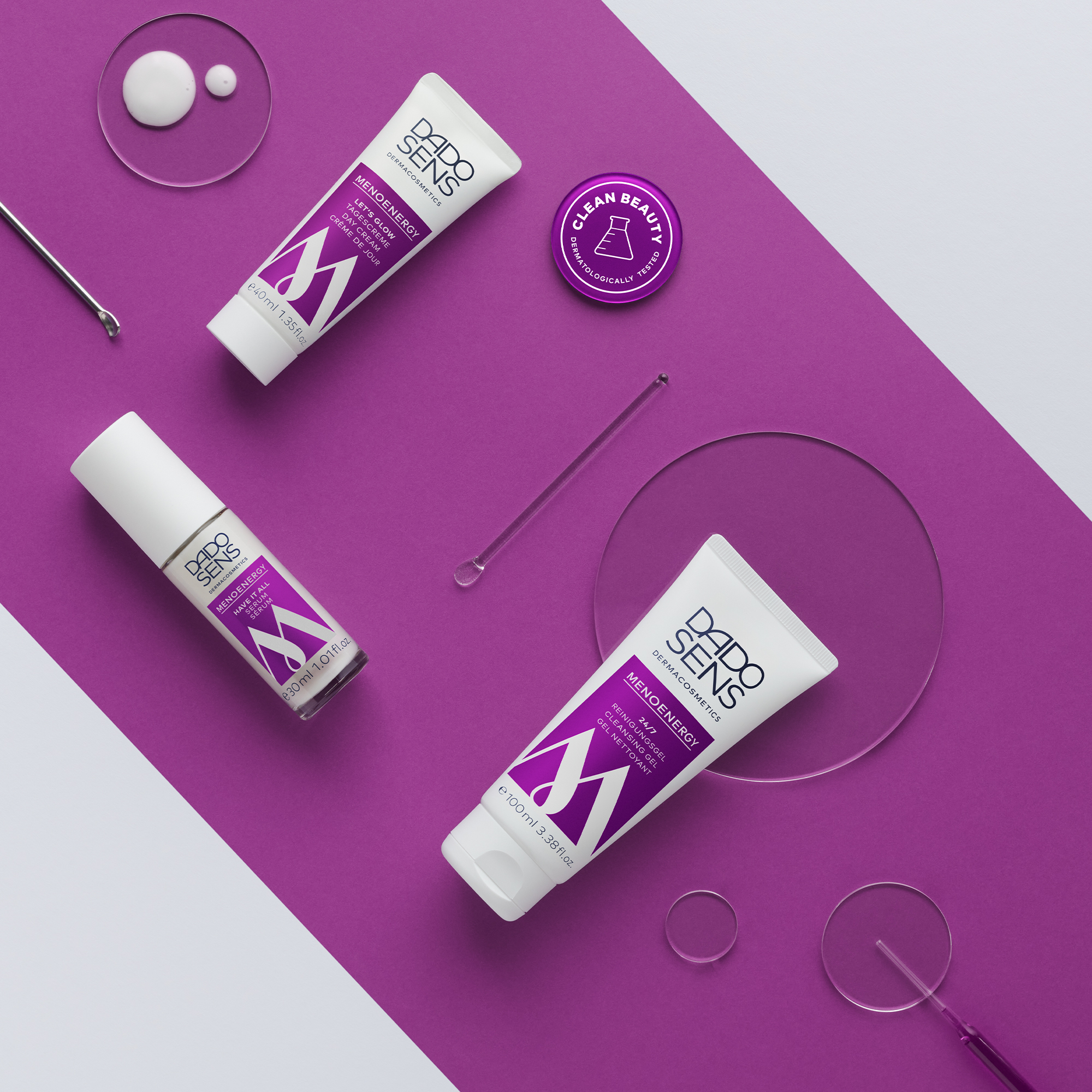DADO SENS MENOENERGY Reinigungs-Gel, Tagescreme und Serum auf lila-weißem Hintergrund mit Clean Beauty Siegel