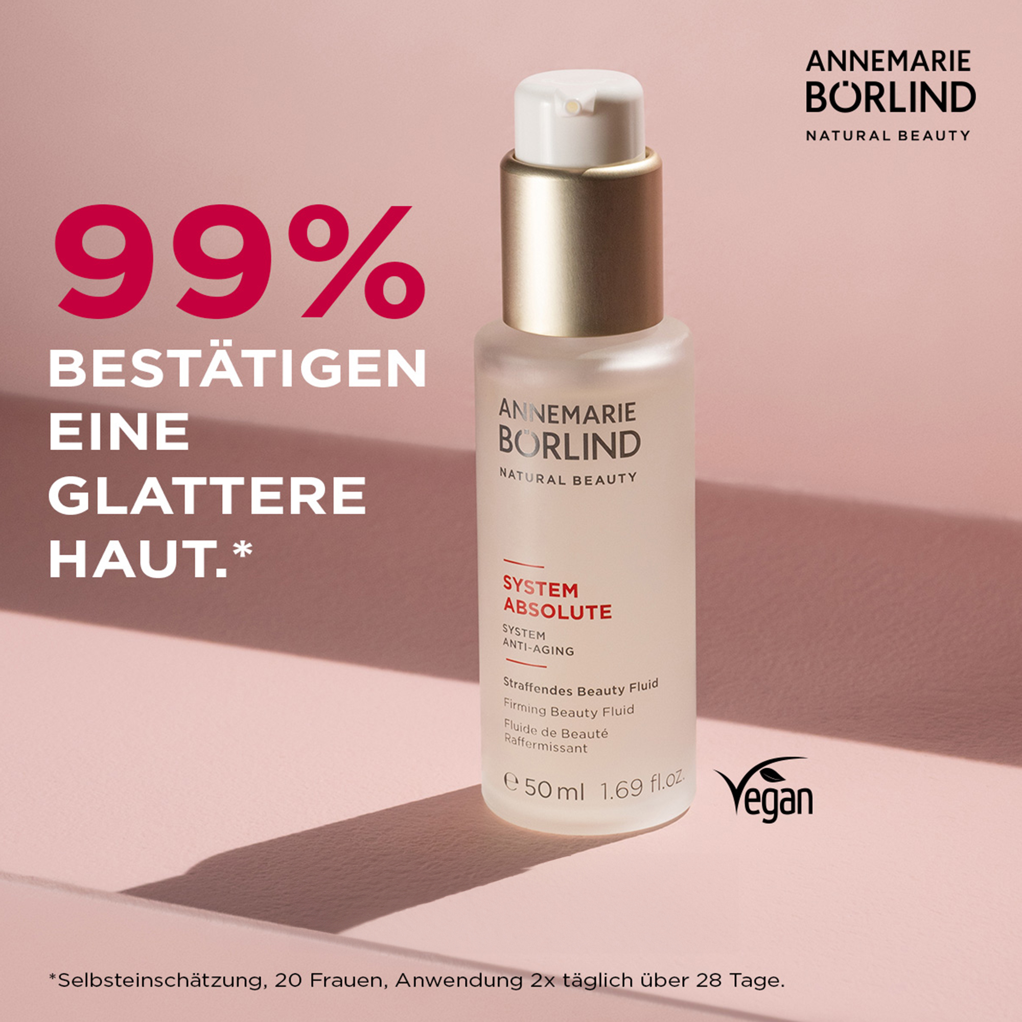 ANNEMARIE BÖRLIND SYSTEM ABSOLUTE straffendes Beauty Fluid 50 ml mit veganem Siegel auf rosa Hintergrund
