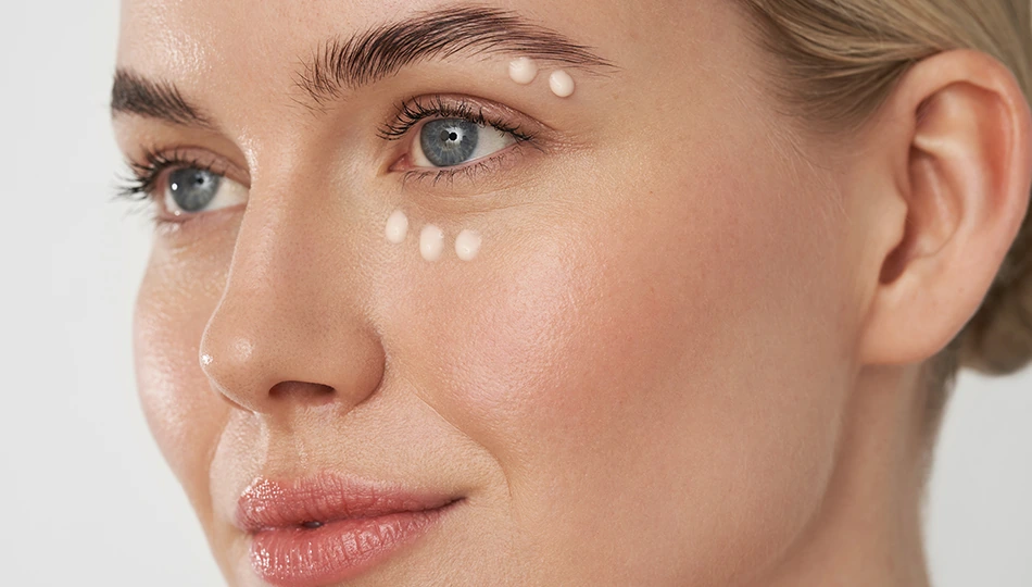Close-up of woman applying eye cream – targeted skincare to slow down skin aging