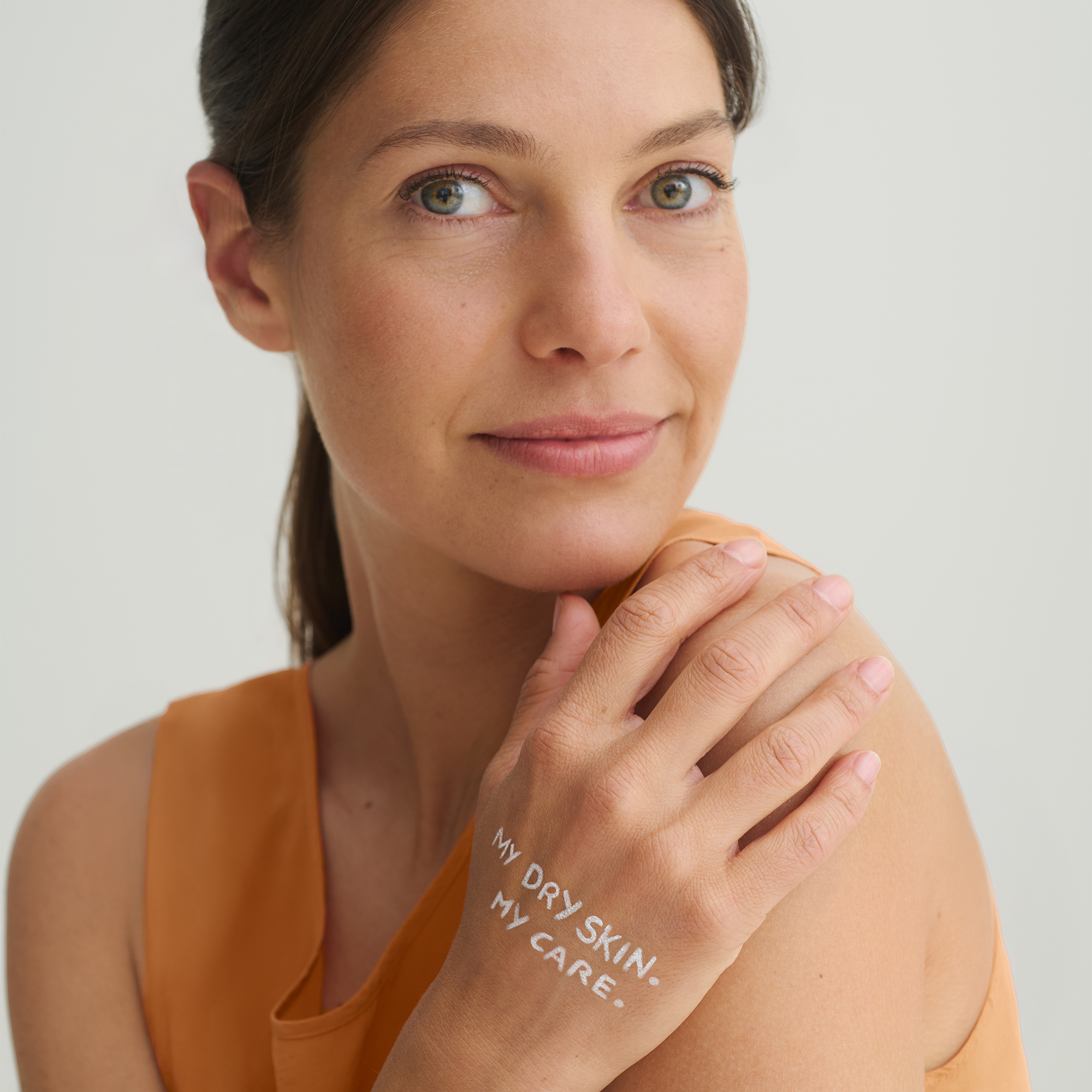 Frau mit Claim MY DRY SKIN. MY CARE. auf der Hand